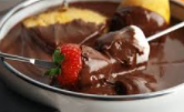 dipping fruit into red wine dark chocolate fondue